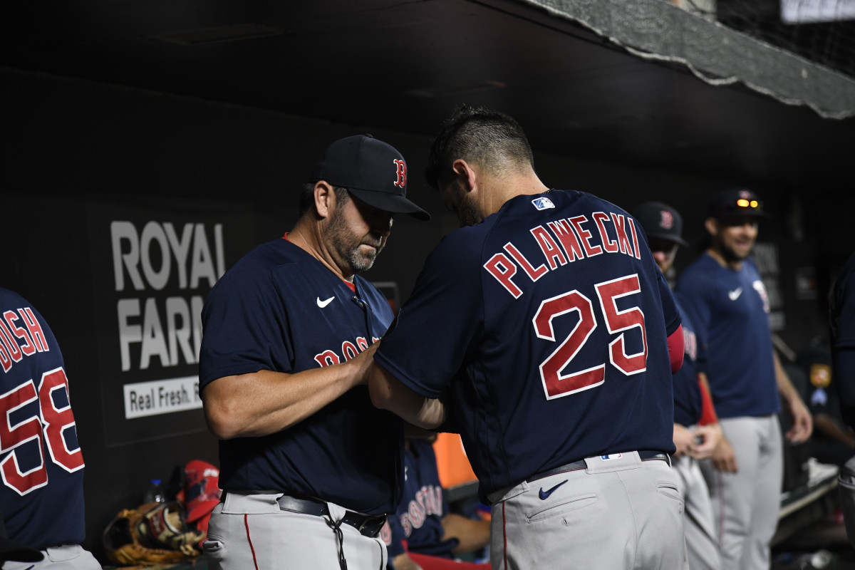 Boston Red Sox game planning coordinator/catching coach Jason Varitek (33) works with catcher Kevin Plawecki (25) in the dugout during the seventh inning against the Baltimore Orioles at Oriole Park at Camden Yards. (2022)